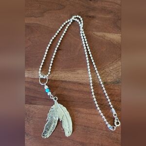 Silver feather pendant necklace